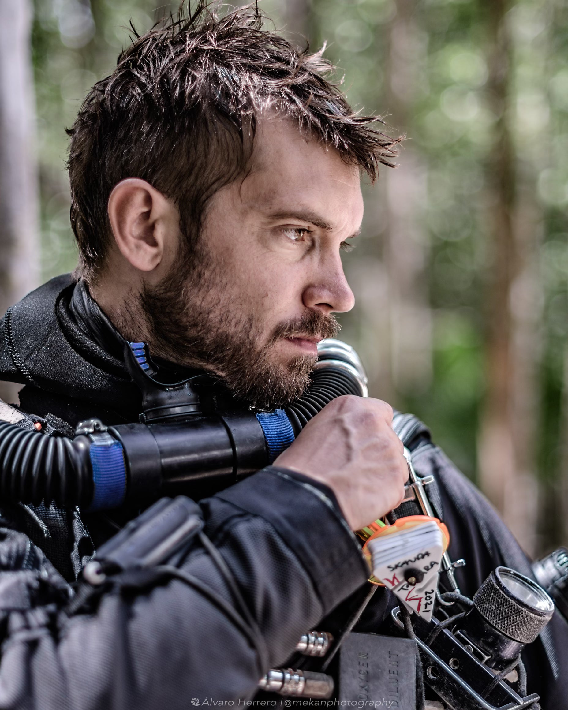 Skanda Coffield @skandacophield fully equipped and wet in diving equipment in a forest 